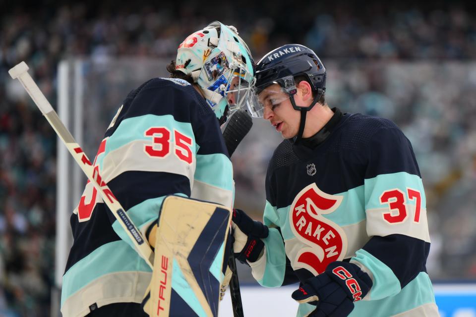 Seattle Kraken goaltender Joey Daccord (35) and center Yanni Gourde (37) celebrate after defeating the Vegas Golden Knights in the 2024 Winter Classic.