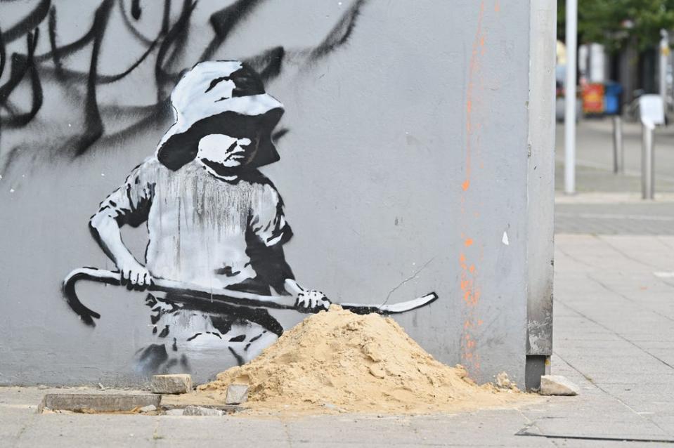 The digging child appeared on an old electrical shop (AFP via Getty Images)