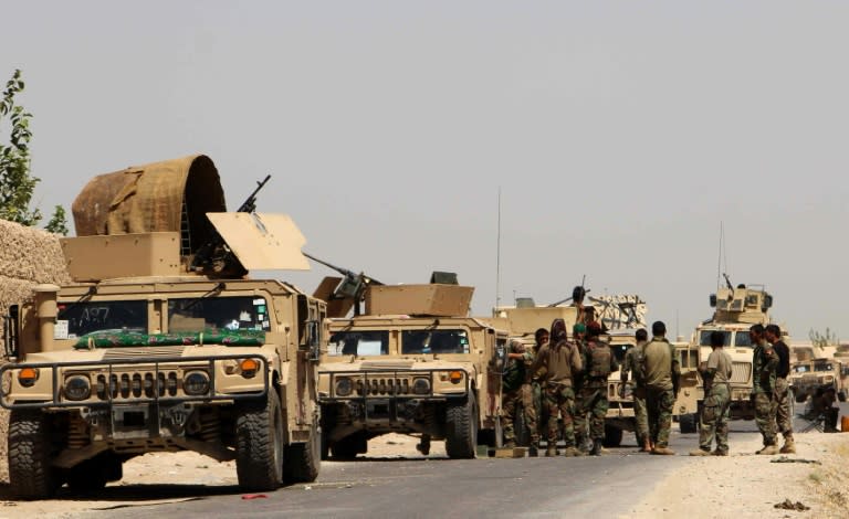 Afghan security personnel prepare for combat during a battle with Taliban militants in Helmand province on August 10, 2016