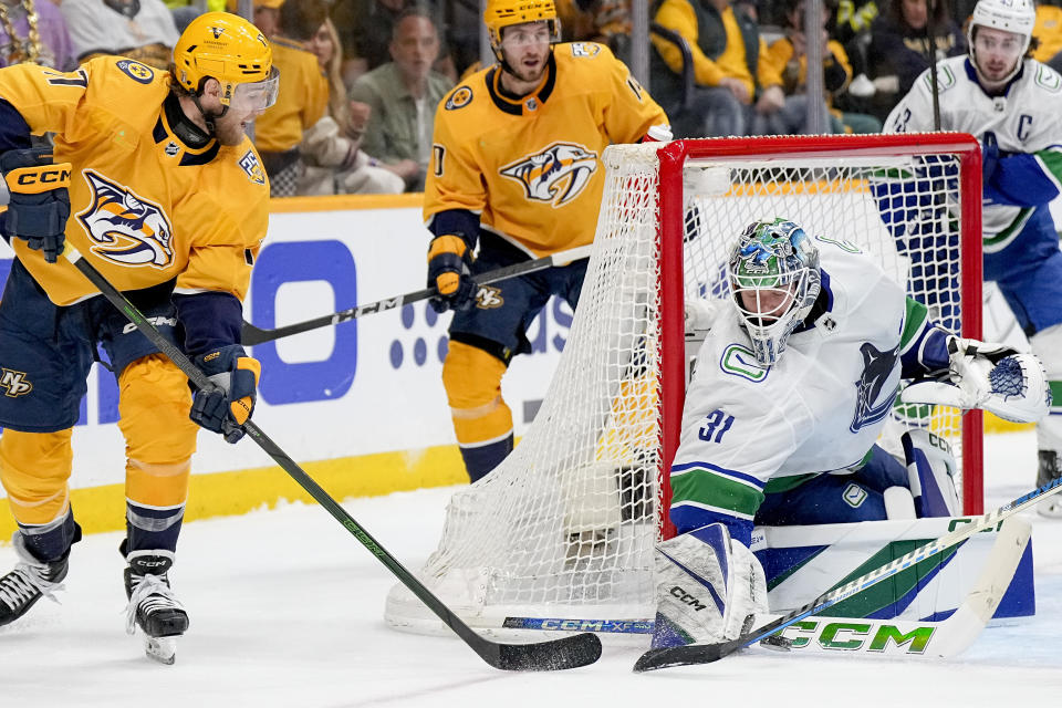 Vancouver Canucks goaltender Arturs Silovs (31) blocks a shot on goal by Nashville Predators center Mark Jankowski, left, during the second period in Game 6 of an NHL hockey Stanley Cup first-round playoff series Friday, May 3, 2024, in Nashville, Tenn. (AP Photo/George Walker IV)