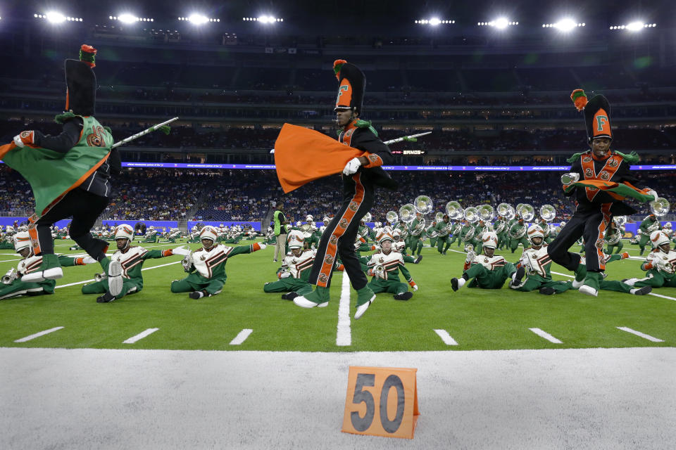 The drum majors lead the Florida A&M University Marching 100 band during their performance at the 2023 National Battle of the Bands, a showcase for HBCU marching bands, held at NRG Stadium, Saturday, Aug. 26, 2023, in Houston. (AP Photo/Michael Wyke)