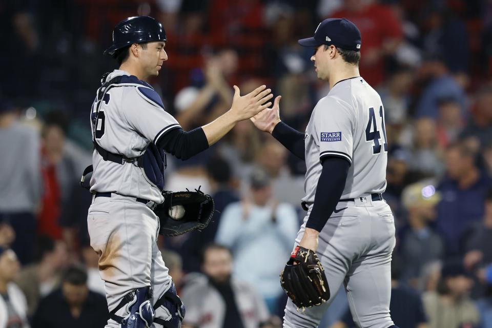 New York Yankees relief pitcher Tommy Kahnle (41) and catcher Kyle Higashioka (66) celebrate the team's win over the Boston Red Sox in the second game of a baseball doubleheader in Boston, Thursday, Sept. 14, 2023. (AP Photo/Michael Dwyer)