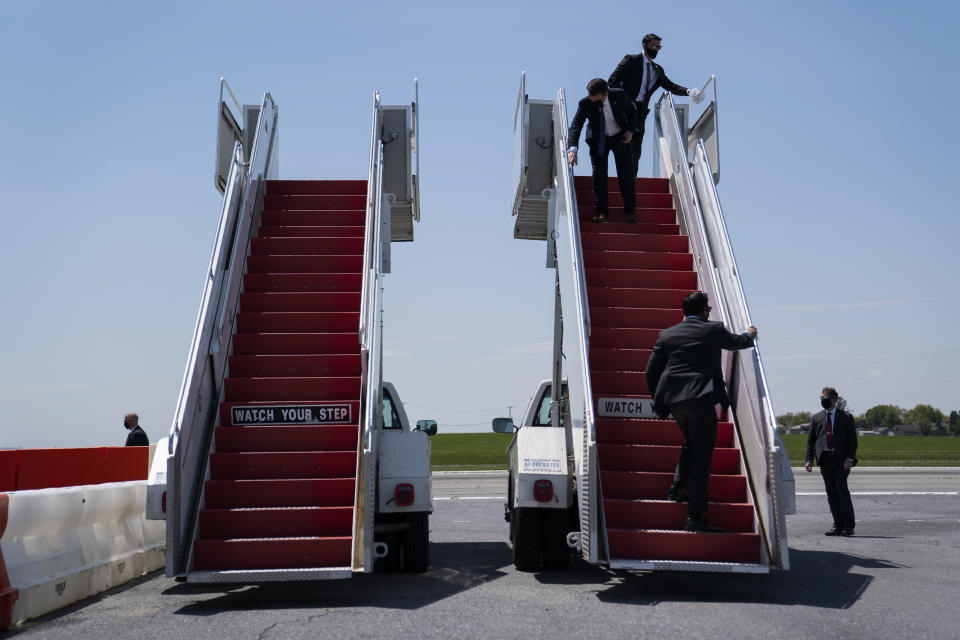 Members of the White House Military Office clean a stair for Air Force One ahead of the arrival of President Donald Trump at Lehigh Valley International Airport, Thursday, May 14, 2020, in Allentown, Pa. (AP Photo/Evan Vucci)