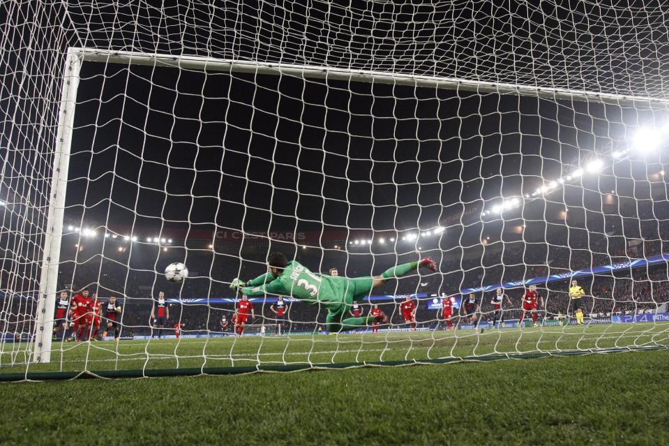 PSG goalkeeper Salvatore Sirigu saves a penalty shot during the Champions League round of 16 second leg soccer match between Paris Saint Germain and Bayer Leverkusen at the Parc des Princes stadium in Paris, Wednesday, March 12, 2014. (AP Photo/Christophe Ena)