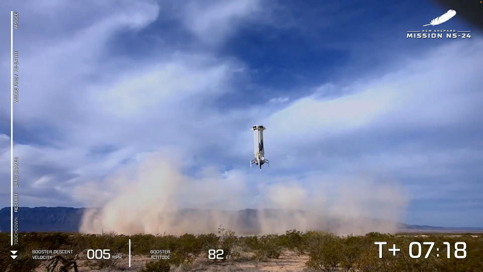 The New Shepard booster landed safely on a nearby pad after boosting the capsule out of the lower atmosphere. / Credit: Blue Origin webcast