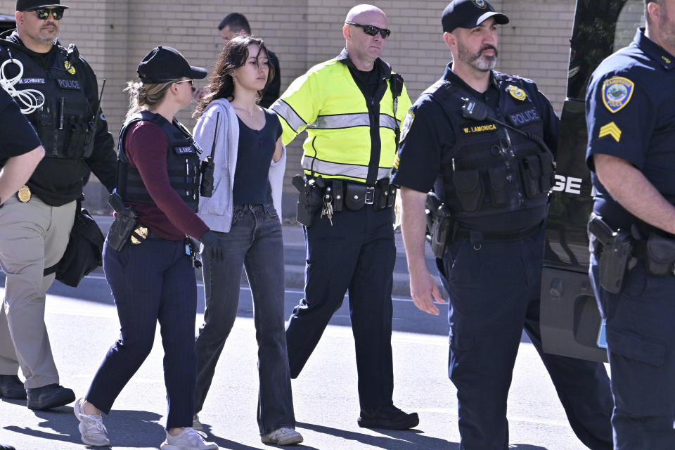 Police detain a pro-Palestinian demonstrator who attempted to block traffic from the garage of the Stata Center at MIT, Thursday, May 9, 2024, in Cambridge, Mass. (AP Photo/Josh Reynolds)