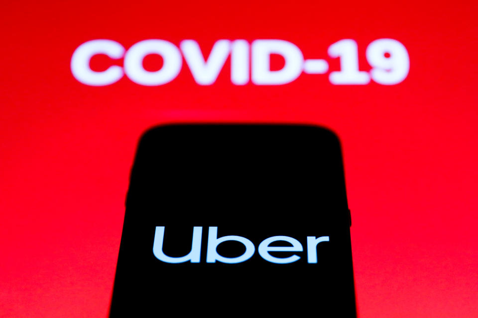 Uber app icon is seen on the smartphone screen with coronavirus sign in the background in this illustration photo taken in Poland on March 21, 2020. (Photo by Jakub Porzycki/NurPhoto via Getty Images)