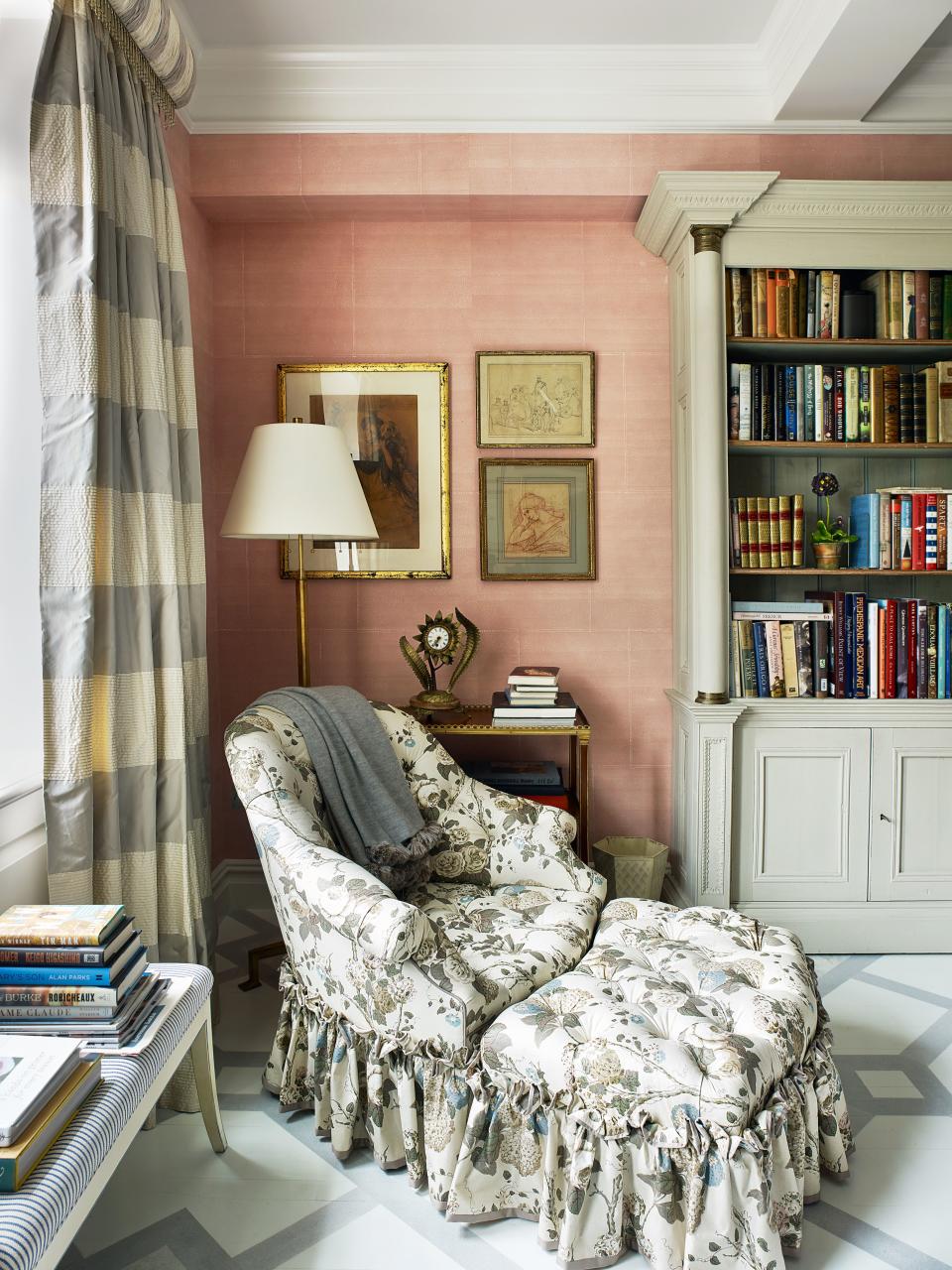 “It’s easy to put the big stuff in a room, but getting all the objects, getting the containers for the flowers—things that make a space come alive—takes a while.” The chair and ottoman by Bunny Williams Home are clad in fabrics by Clarence House and Schumacher; 19th-century bookcase.