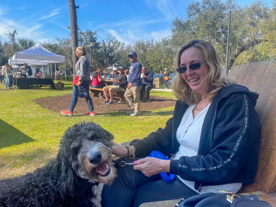 Gosia Jansen lived on Hilton Head Island for about 18 years before moving to Bluffton around 2005. In this photo taken Feb. 22, 2024 at the Bluffton Farmer’s Market, she sits with her Bernadoodle, Bryza, which means breeze in Polish.