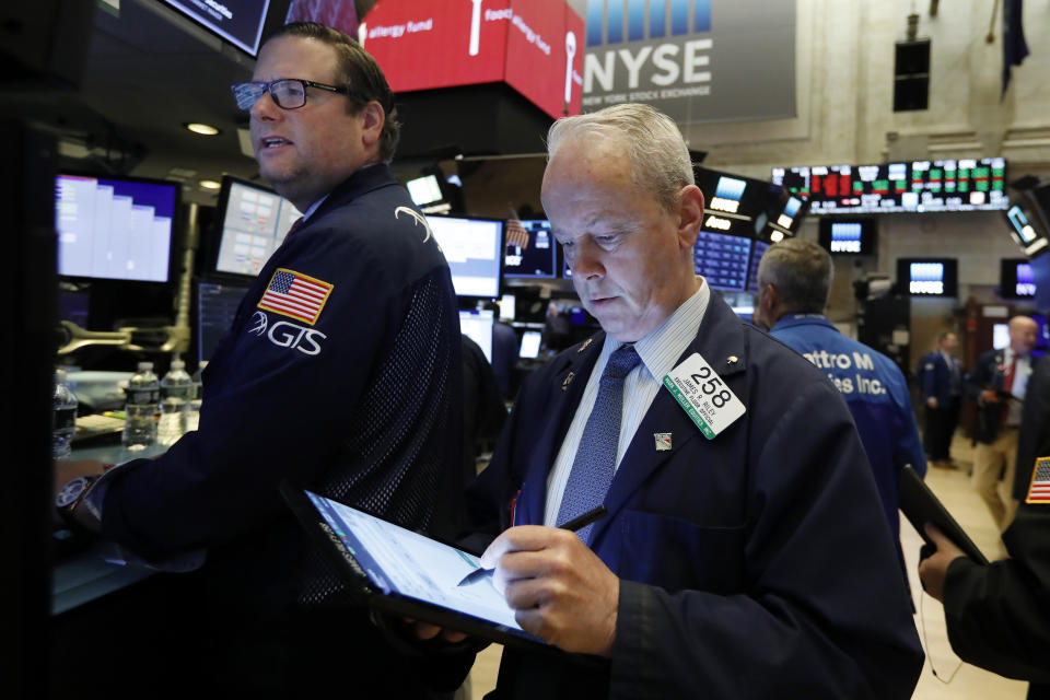 Specialist Gregg Maloney, left, and trader James Riley works on the floor of the New York Stock Exchange, Thursday, May 30, 2019. Stocks are edging higher in early trading on Wall Street following two days of losses. (AP Photo/Richard Drew)