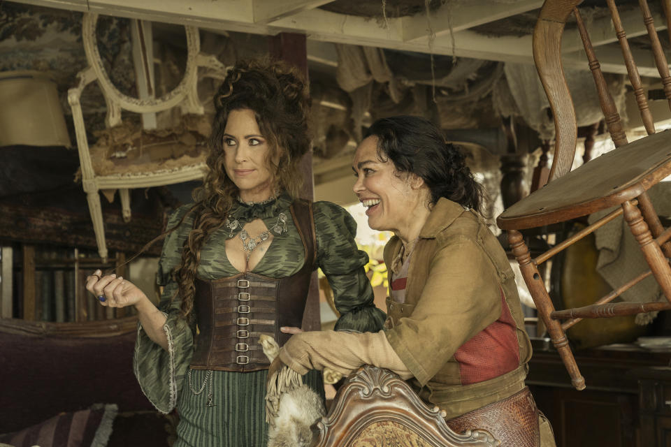 Our Flag Means Death Image by Nicola Dove of Minnie Driver and Rachel House as Anne Bonny and Mary Read in their antique shop. 