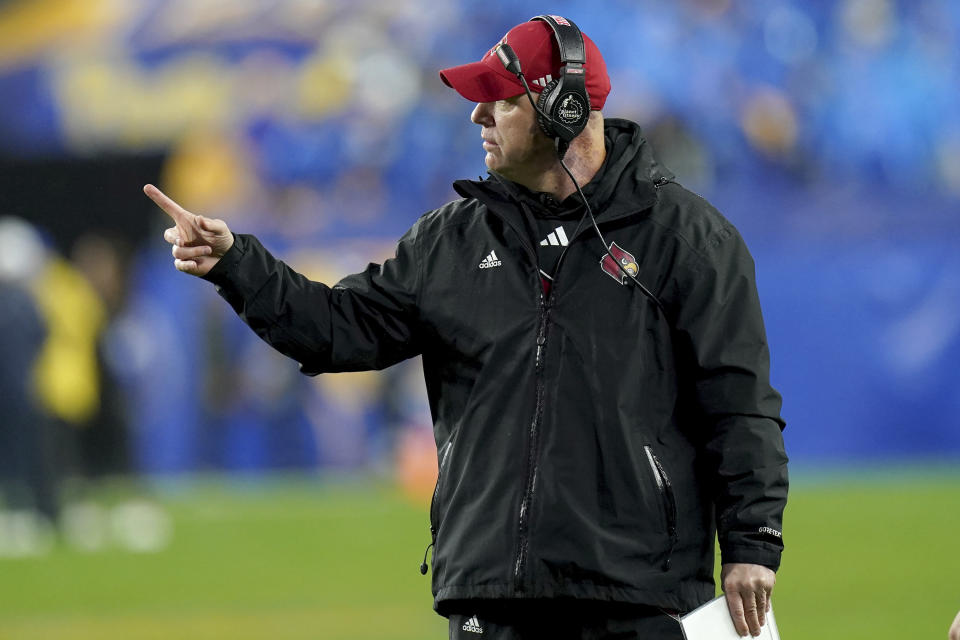 Louisville coach Jeff Brohm motions to an official during the first half of the team's NCAA college football game against Pittsburgh in Pittsburgh, Saturday, Oct. 14, 2023. (AP Photo/Matt Freed)