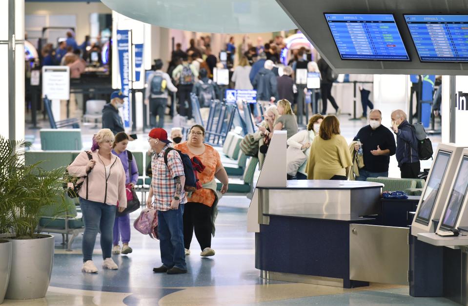 Jacksonville International Airport travelers prepare for their flights Thursday after JAX saw a record number of passengers last year.