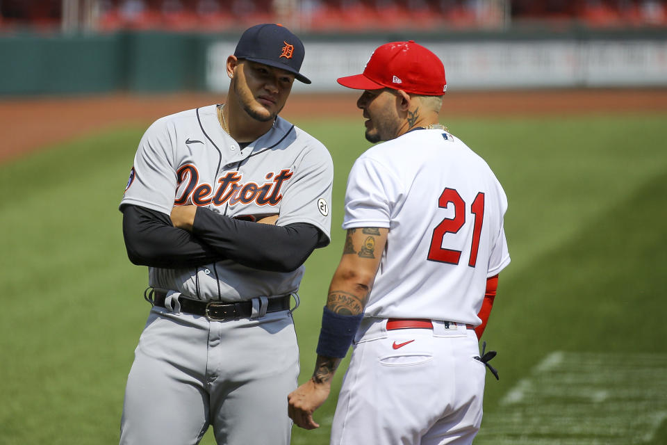 Detroit Tigers' Joe Jimenez, left, talkes with St. Louis Cardinals' Yadier Molina prior to the start of the first game of a baseball doubleheader Thursday, Sept. 10, 2020, in St. Louis. Both players are wearing the number 21 in honor of Roberto Clemente. (AP Photo/Scott Kane)