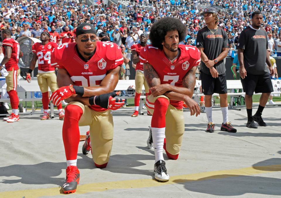 In this Sept. 18, 2016, file photo, San Francisco 49ers' Colin Kaepernick (7) and Eric Reid (35) kneel during the national anthem before an NFL football game against the Carolina Panthers in Charlotte, N.C.