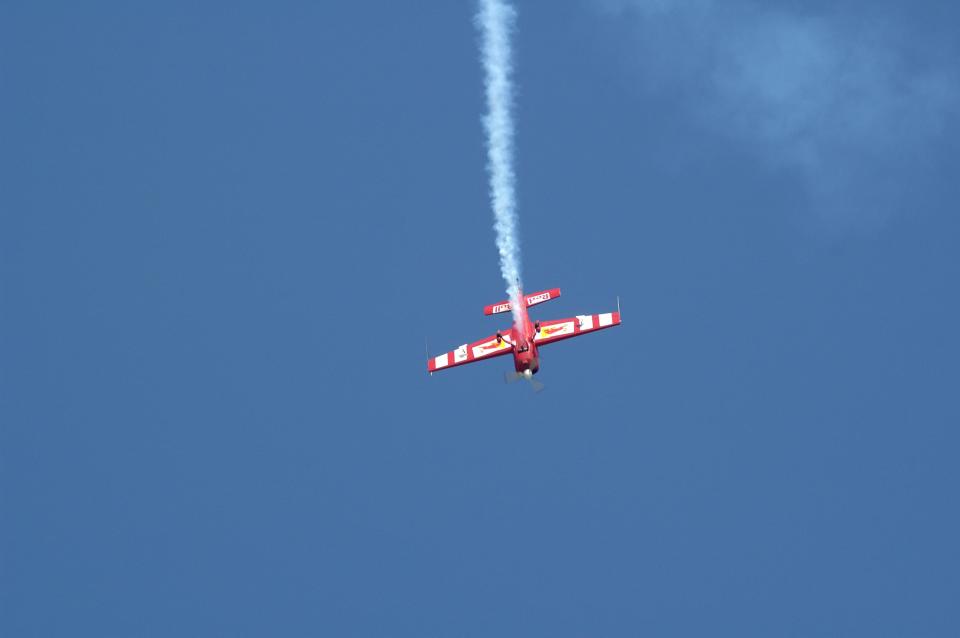 Piper plane performing spectacular display at an aerobatic air show