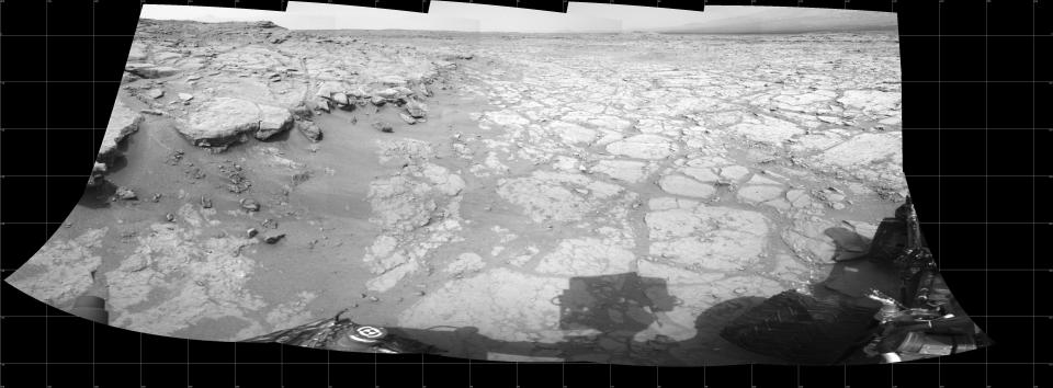 In a shallow depression called "Yellowknife Bay," the NASA Mars rover Curiosity drove to an edge of the feature during the 130th Martian day, or sol, of the mission (Dec. 17, 2012) and used its Navigation Camera to record this view of the ledge at the margin and a view across the "bay." (NASA/JPL-Caltech)