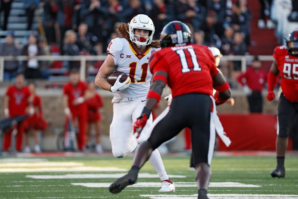 Iowa State's Chase Allen (11) runs with the ball around Texas Tech's Eric Monroe (11) on Nov. 13 in Lubbock, Texas.