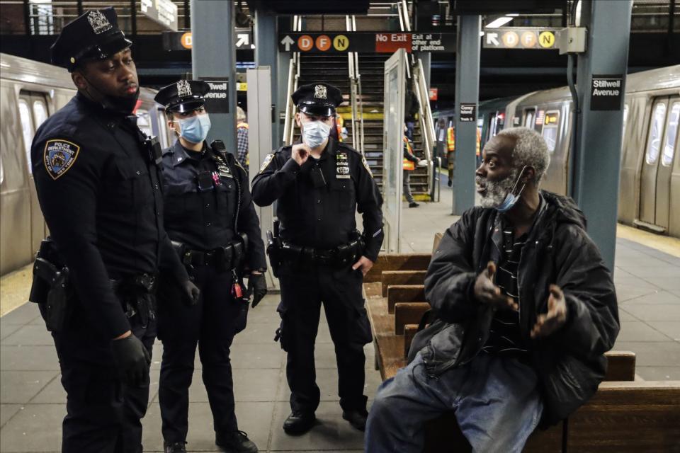 Police officers notify a man that the Coney Island, Stillwell Terminal is closed May 6.