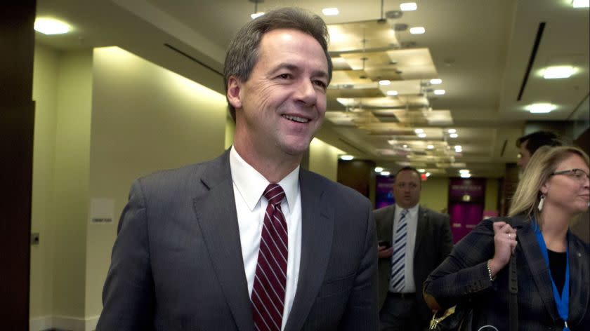 FILE -In this Feb. 23, 2019, file photo, Montana Gov. Steve Bullock walks to a meeting during the National Governors Association 2019 winter meeting in Washington. (AP Photo/Jose Luis Magana, File)