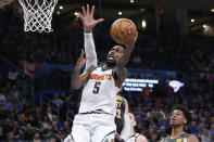 Denver Nuggets forward Will Barton (5) shoots in front of Oklahoma City Thunder center Steven Adams, rear, in the first half of an NBA basketball game Friday, Feb. 21, 2020, in Oklahoma City. (AP Photo/Sue Ogrocki)
