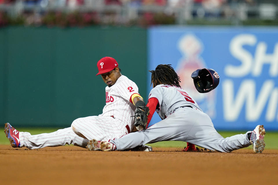 Washington Nationals' CJ Abrams, right, steals second past Philadelphia Phillies second baseman Jean Segura during the fourth inning of a baseball game, Friday, Sept. 9, 2022, in Philadelphia. (AP Photo/Matt Slocum)