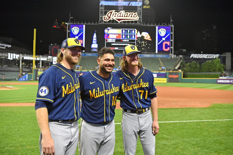 Starting pitcher Corbin Burnes (left) catcher Omar Narvaez (center) and closing pitcher Josh Hader of the Milwaukee Brewers pose for a picture in front of the scoreboard after the Brewers threw a combined no-hitter to defeat the Cleveland Indians at Progressive Field on September 11, 2021 in Cleveland, Ohio. The Brewers defeated the Indians 3-0.