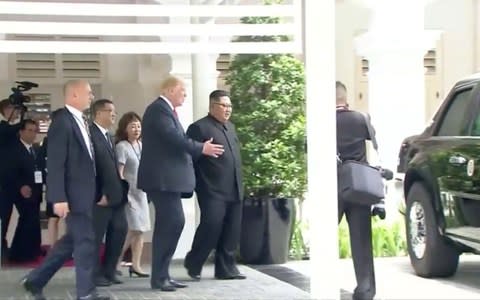 Mr Trump taking Mr Kim to see his presidential limousine - Credit: Reuters