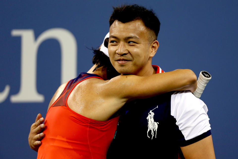 NEW YORK, NY - AUGUST 26:  Francesca Schiavone of Italy hugs a ball boy during her first round women's singles match against Serena Williams of the United States of America on Day One of the 2013 US Open at USTA Billie Jean King National Tennis Center on August 26, 2013 in the Flushing neighborhood of the Queens borough of New York City.  (Photo by Matthew Stockman/Getty Images)