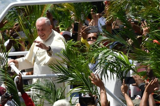 Throngs of cheering faithful waving palm fronds lined the streets of Port Louis as the popemobile shuttled the Argentine pontiff to the hilltop Mary Queen of Peace Monument