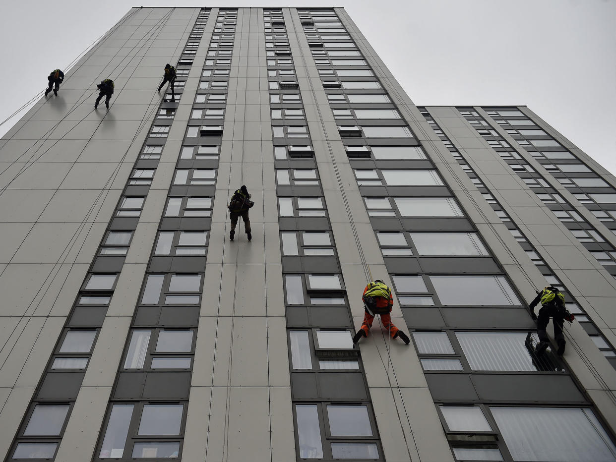 Specialists abseil down the side of Bray Tower to check the cladding on the Chalcots Estate in north London (file photo): Reuters