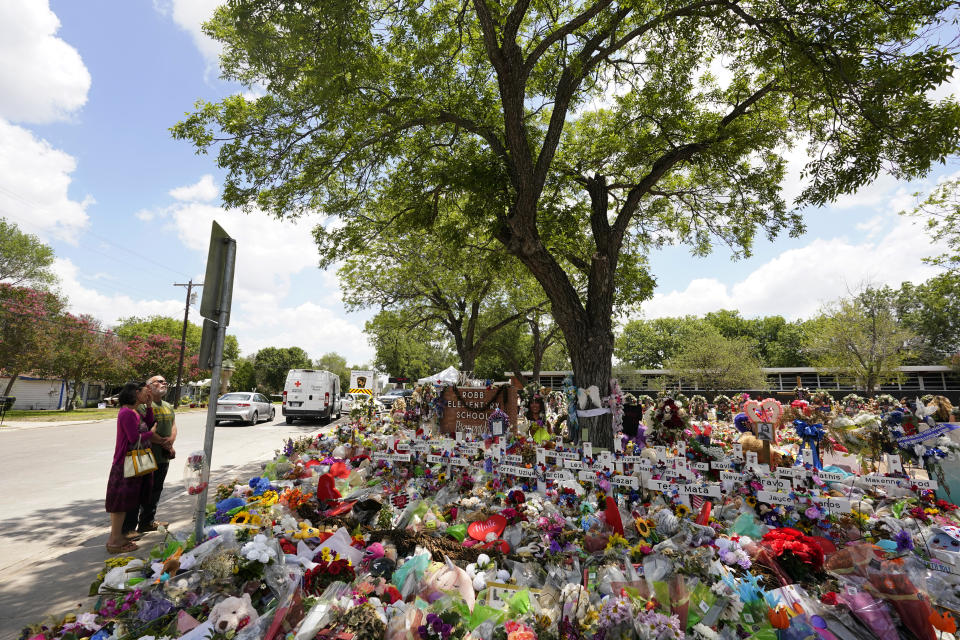 Pecan trees, planted in the 1960's, shade a memorial created to honor the victims killed in the recent school shooting at Robb Elementary, Thursday, June 9, 2022, in Uvalde, Texas. The Texas elementary school where a gunman killed 19 children and two teachers has long been a part of the fabric of the small city of Uvalde, a school attended by generations of families, and where the spark came that led to Hispanic parents and students to band together to fight discrimination over a half-century ago. (AP Photo/Eric Gay)