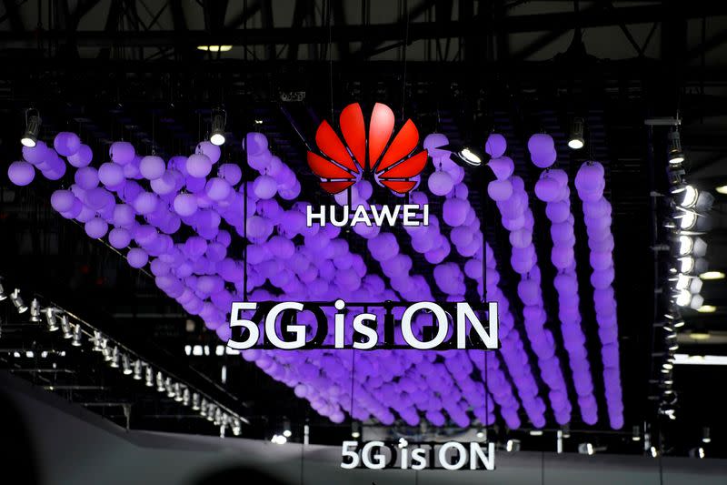 FILE PHOTO: A Huawei logo and a 5G sign are pictured at Mobile World Congress (MWC) in Shanghai