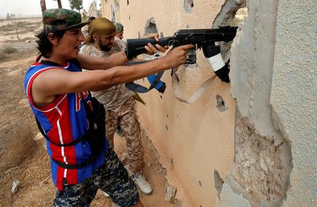 Libyan forces allied with the U.N.-backed government fire weapons during a battle with Islamic State fighters in Sirte. REUTERS/Goran Tomasevic