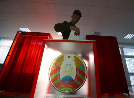 A Belarussian serviceman casts his ballot at a polling station during a parliamentary election, in Minsk, Belarus September 11, 2016. REUTERS/Vasily Fedosenko