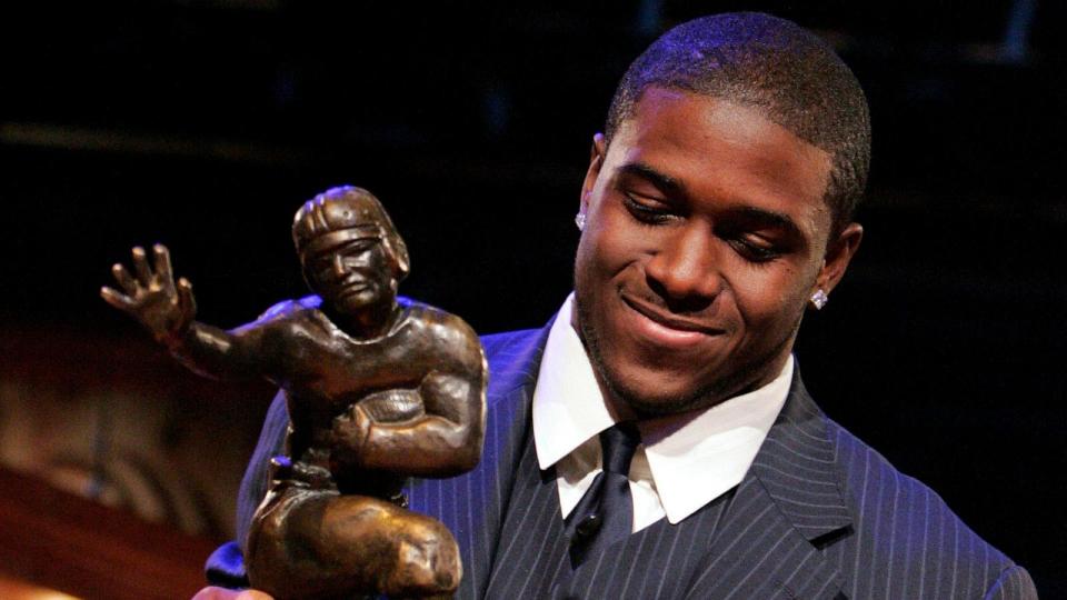 PHOTO: In this Dec. 10, 2005 file photo Southern California tailback Reggie Bush picks up the Heisman Trophy after being announced as the winner of the award in New York. (Julie Jacobson/AP, FILE)