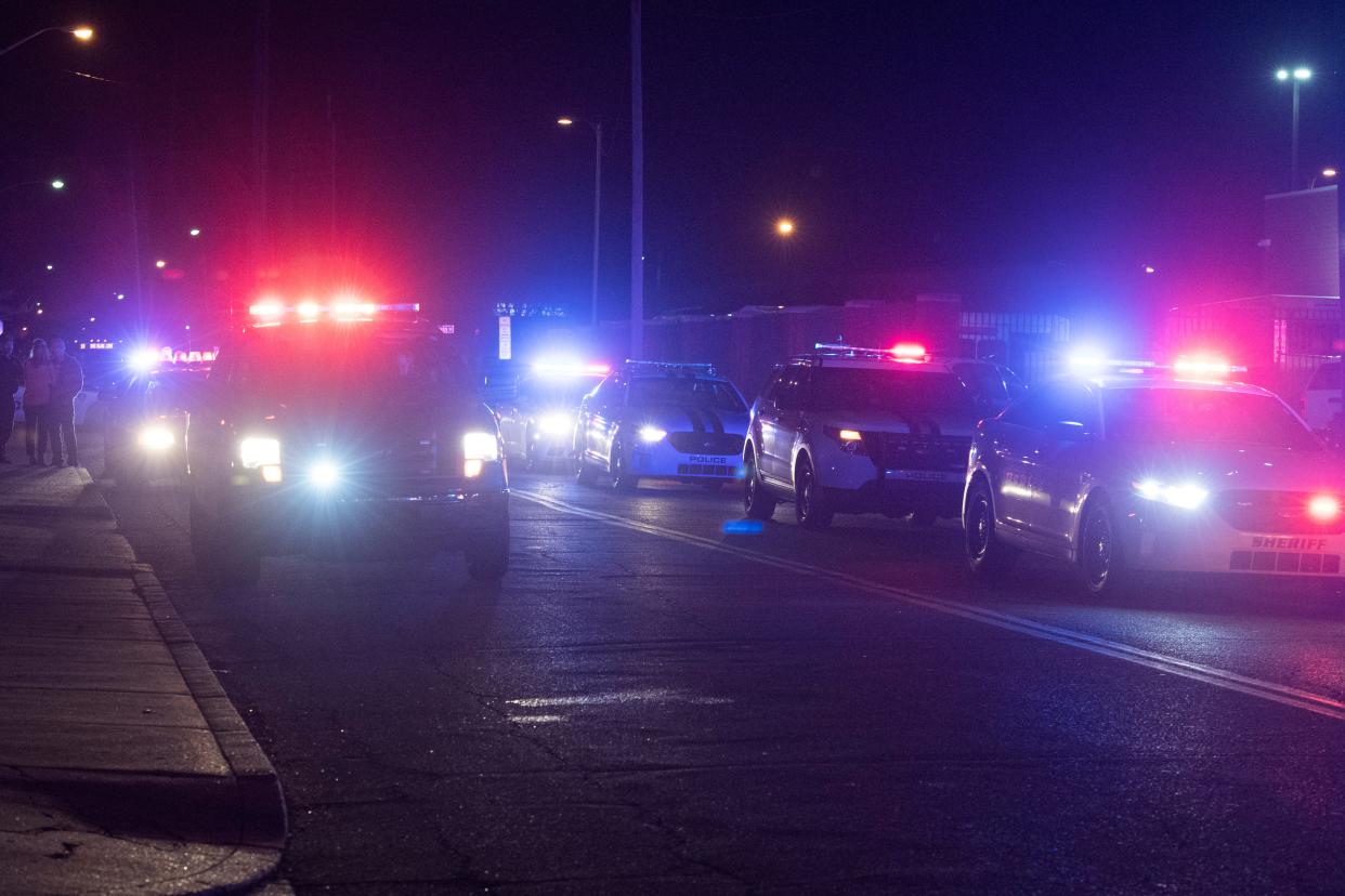 A police caravan on the corner of East Sycamore Street and Morton Avenue accompany the body of an Evansville firefighter Robert Doerr to the Vanderburgh County Coroner's Office Tuesday night, Feb. 26, 2019. Doerr was shot and killed outside his home and police are investigating.