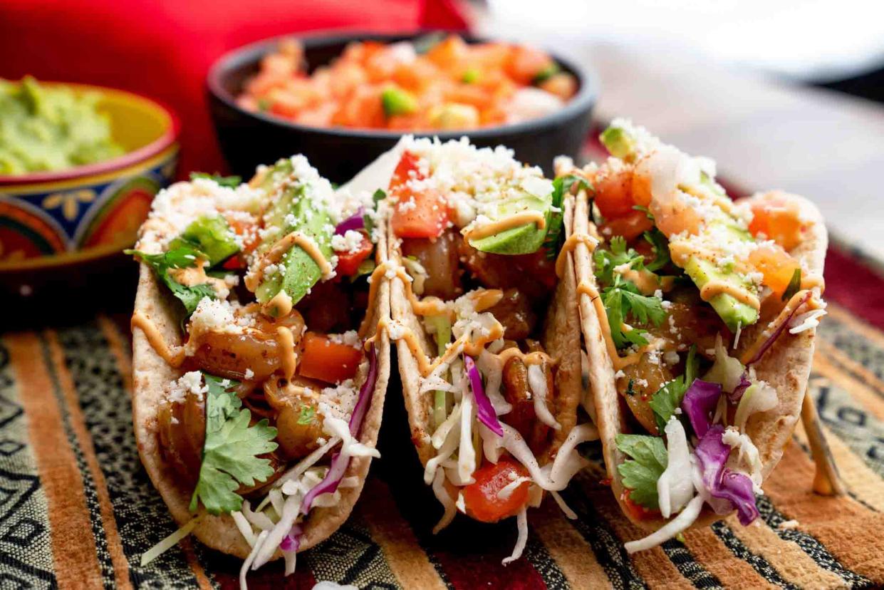 seafood tacos in line on patterned tablecloth