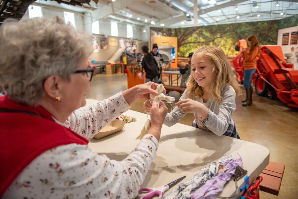 Sharon Seegmiller, left, helps Gemma Gibson, 8, make a rag doll at the San Joaquin County Historical Museum's Festival of Trees on Dec. 7, 2019.