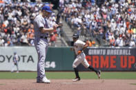 San Francisco Giants' Evan Longoria, right, rounds the bases after hitting a home run off of New York Mets pitcher Thomas Szapucki, foreground, during the second inning of a baseball game in San Francisco, Wednesday, May 25, 2022. (AP Photo/Jeff Chiu)