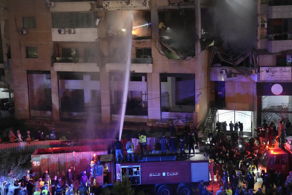 Firefighters extinguish the fire inside an apartment following a massive explosion in the southern suburb of Beirut, Lebanon, Tuesday, Jan. 2, 2024. The TV station of Lebanon's Hezbollah group says top Hamas official Saleh Arouri was killed Tuesday in an explosion in a southern Beirut suburb. (AP Photo/Hussein Malla)