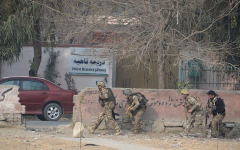 Afghan army soldiers take positions near an office of the British charity Save the Children  - Credit: NOORULLAH SHIRZADA /AFP