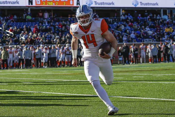 American Team quarterback Sam Howell (14), of North Carolina, runs 2 yards into the end zone for a touchdown during the third quarter of an NCAA Senior Bowl college football game, Saturday, Feb. 5, 2022, in Mobile, Ala. (AP Photo/Butch Dill)