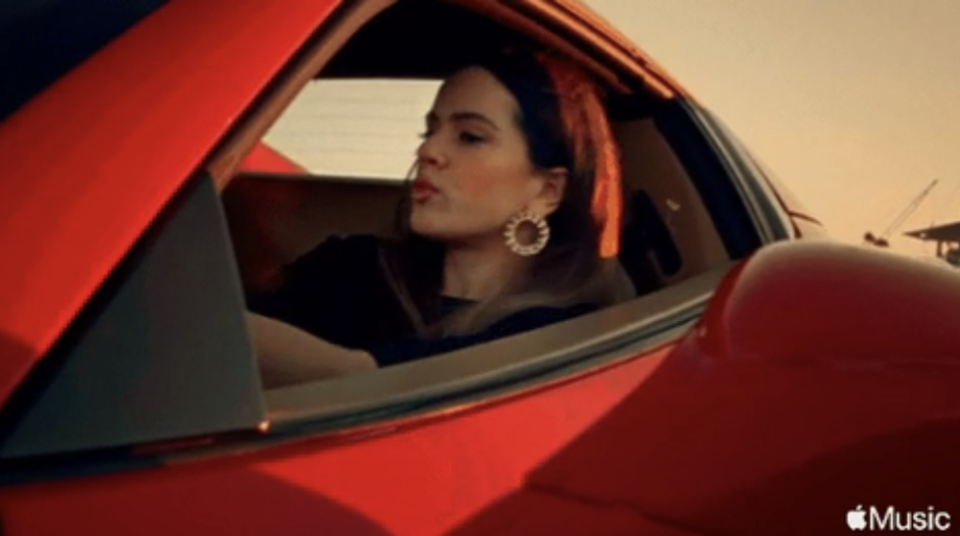 Closeup of a woman driving a red car