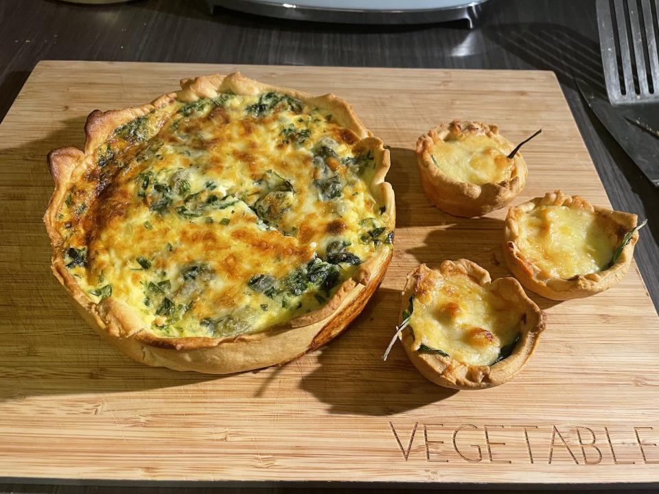 A view of Coronation Quiche and three little Coronation Chicken tarts with spinach and cheese.