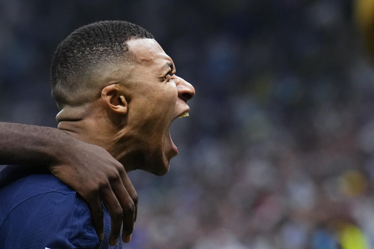 France's Kylian Mbappe celebrates scoring his side's second goal during the World Cup final soccer match between Argentina and France at the Lusail Stadium in Lusail, Qatar, Sunday, Dec. 18, 2022. (AP Photo/Natacha Pisarenko)