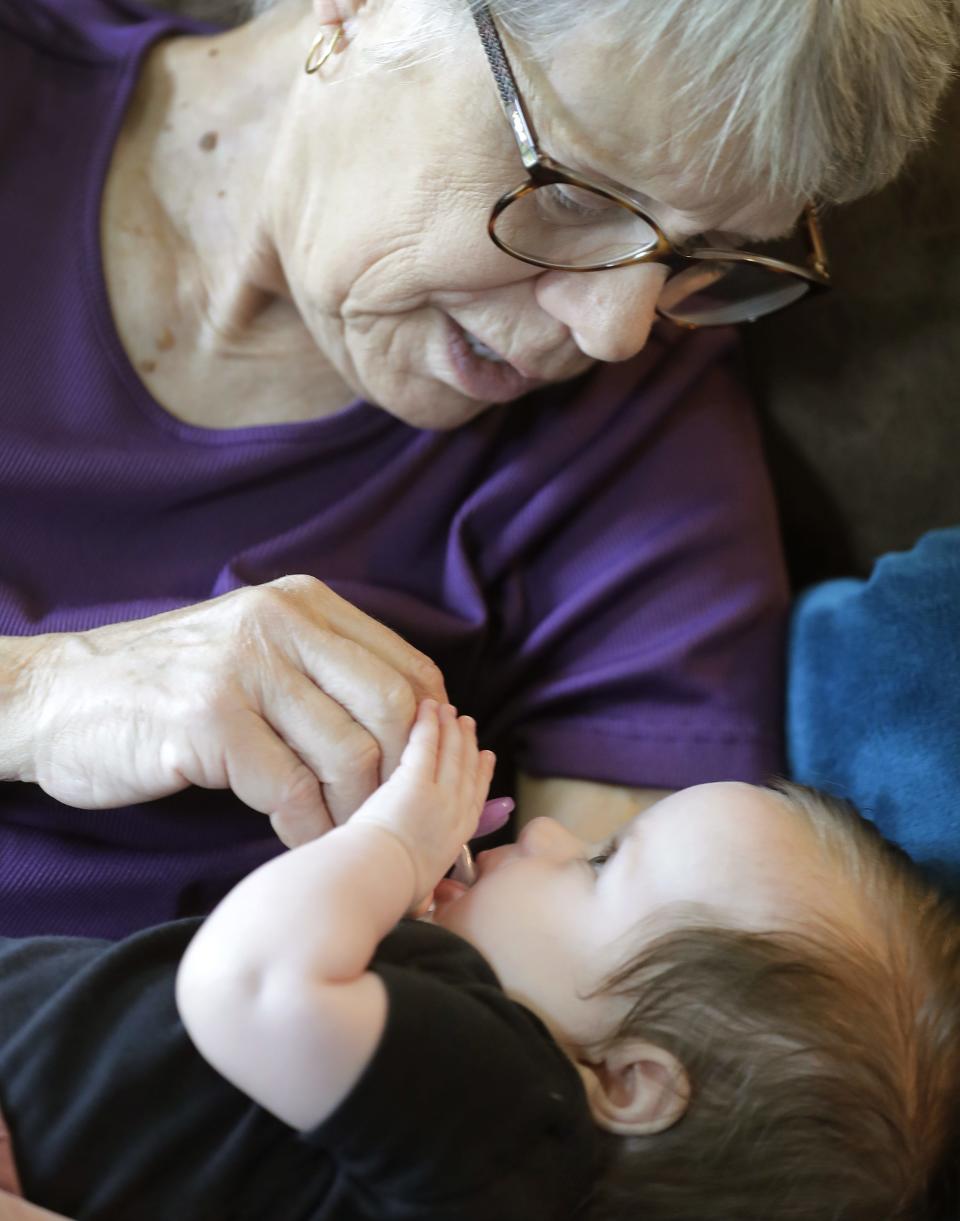 Gloria Mathews cares for her then 5-month-old granddaughter, Emma, on June 20 in Appleton. Due to a lack of childcare, Carolyn Nelson and her husband rely on her mom to drive 2.5 hours from Beloit to take care of Emma when she needs to work.