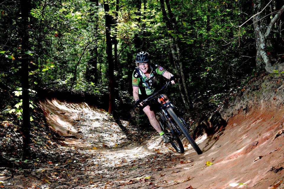 Tracey Armstrong hits a burm as she demonstrates one of the many mountain biking trails in the Bent Creek Experimental Forest in 2017. In the last Nantahala Pisgah National Forest Management Plan released in 1987 and amended in 1994 mountain biking wasn't even mentioned.