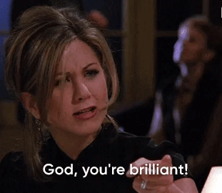 gif of Rachel from Friends in a dark top expresses admiration with a hand gesture that reads god. you're brilliant