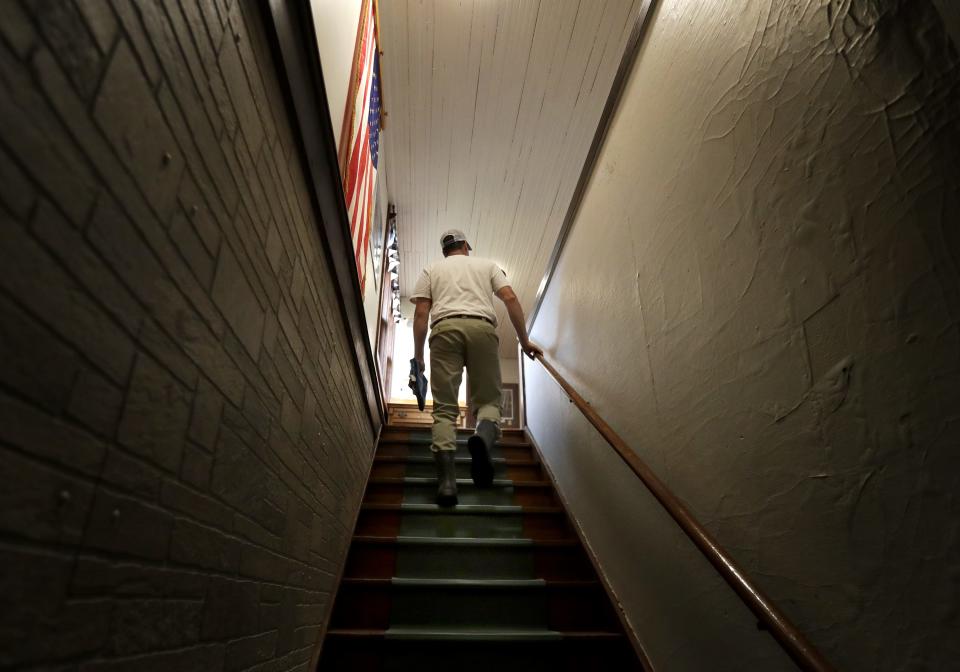 Jon Metzig walks upstairs from the cheese factory floor to the family's former living space, which now serves as office space.